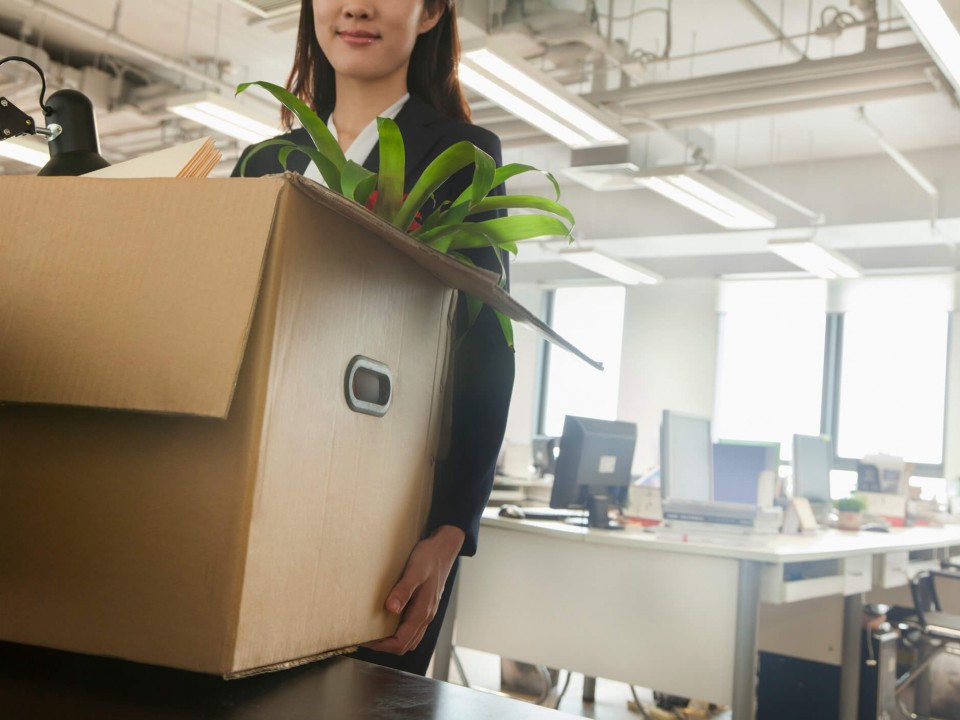 young business woman moving box with office supplies