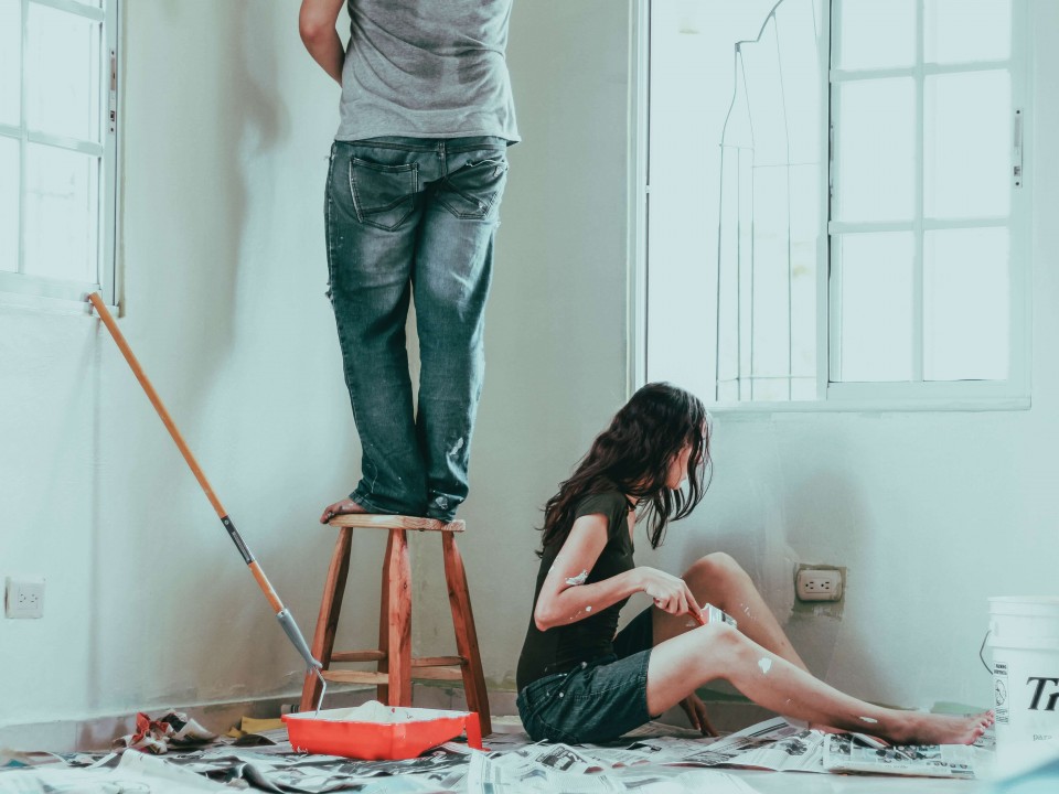Man and woman painting a room 