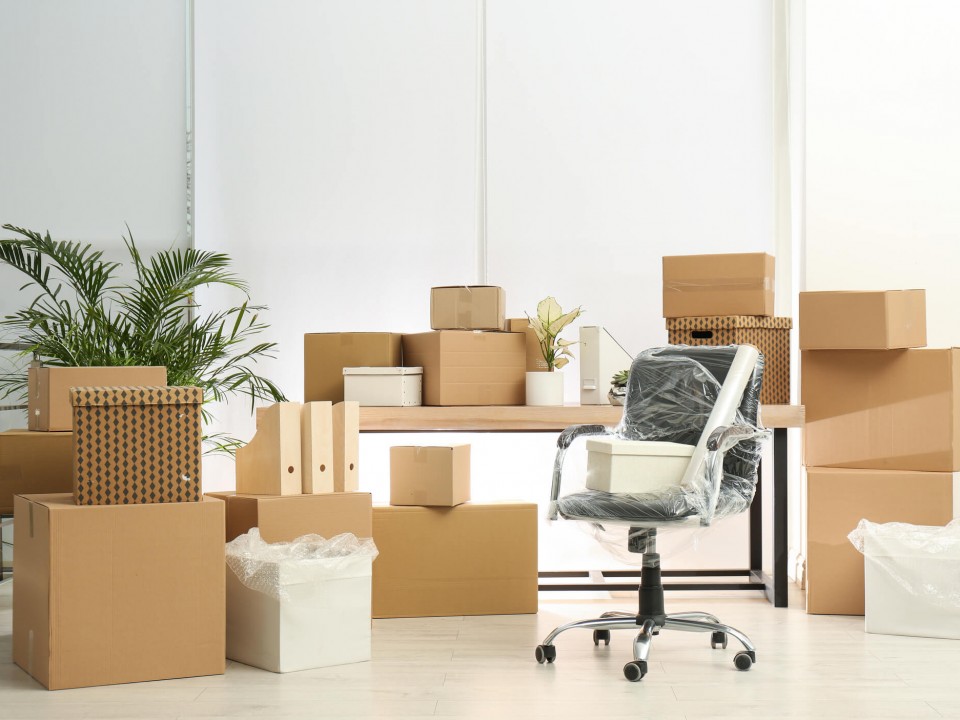 cardboard boxes and packed office chair 