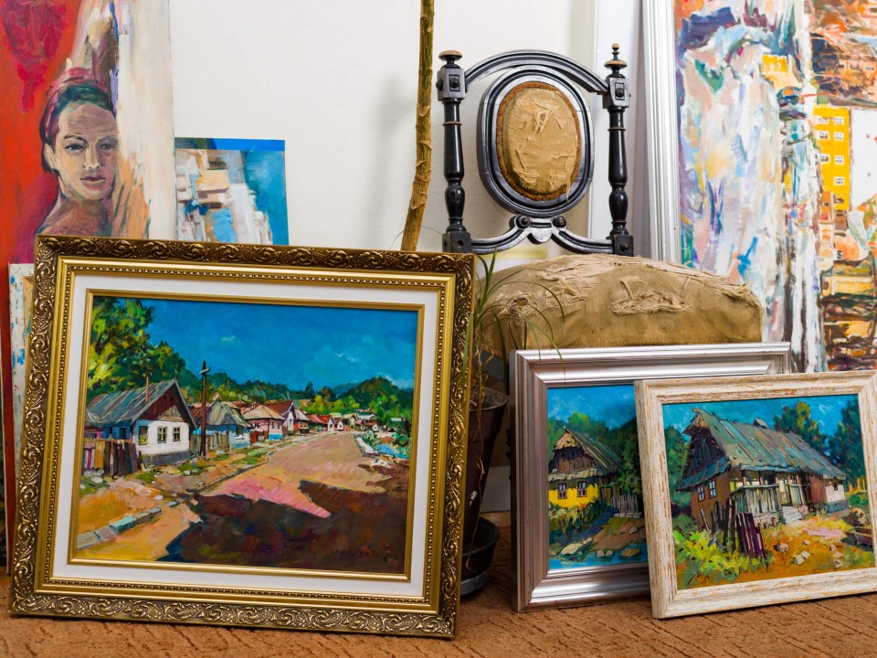 collection of framed paintings