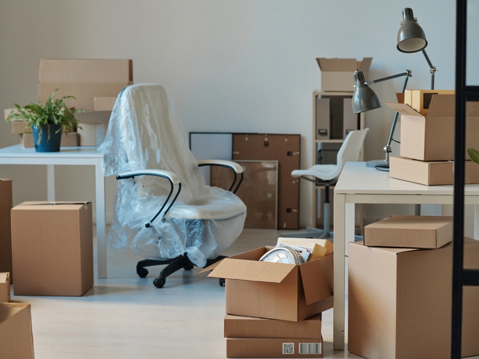 an office with furniture boxed up